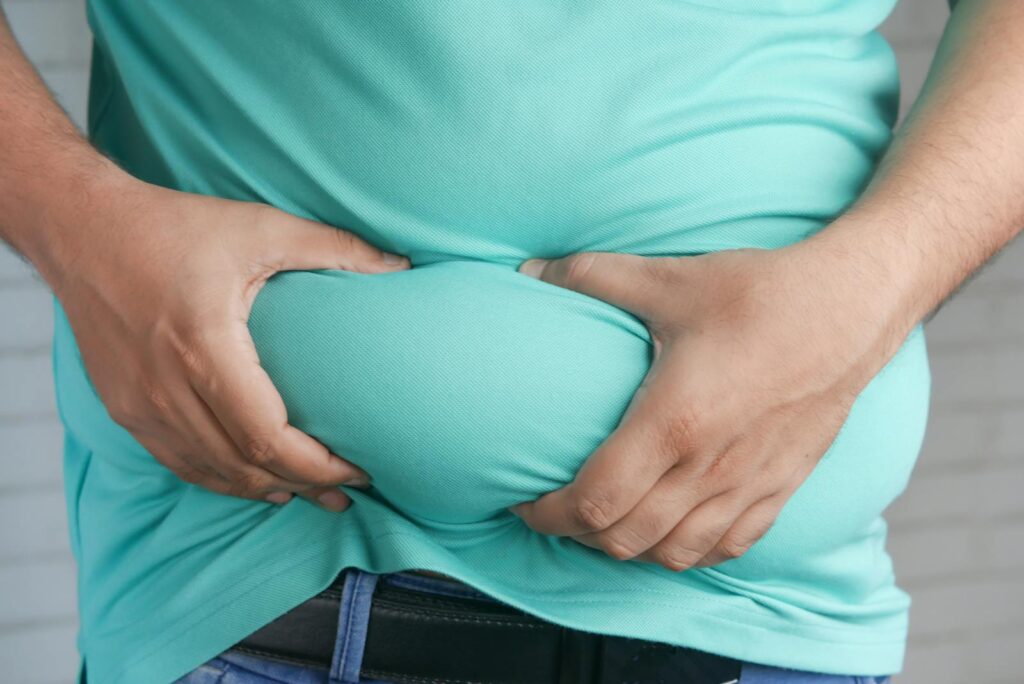 Czy przy cukrzycy się tyje? 16 A Person Holding his Belly Fat